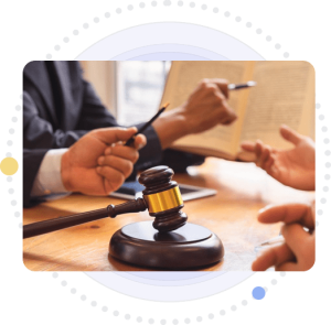 A judge holding a gavel, while another judge stands beside them, holding up a book.